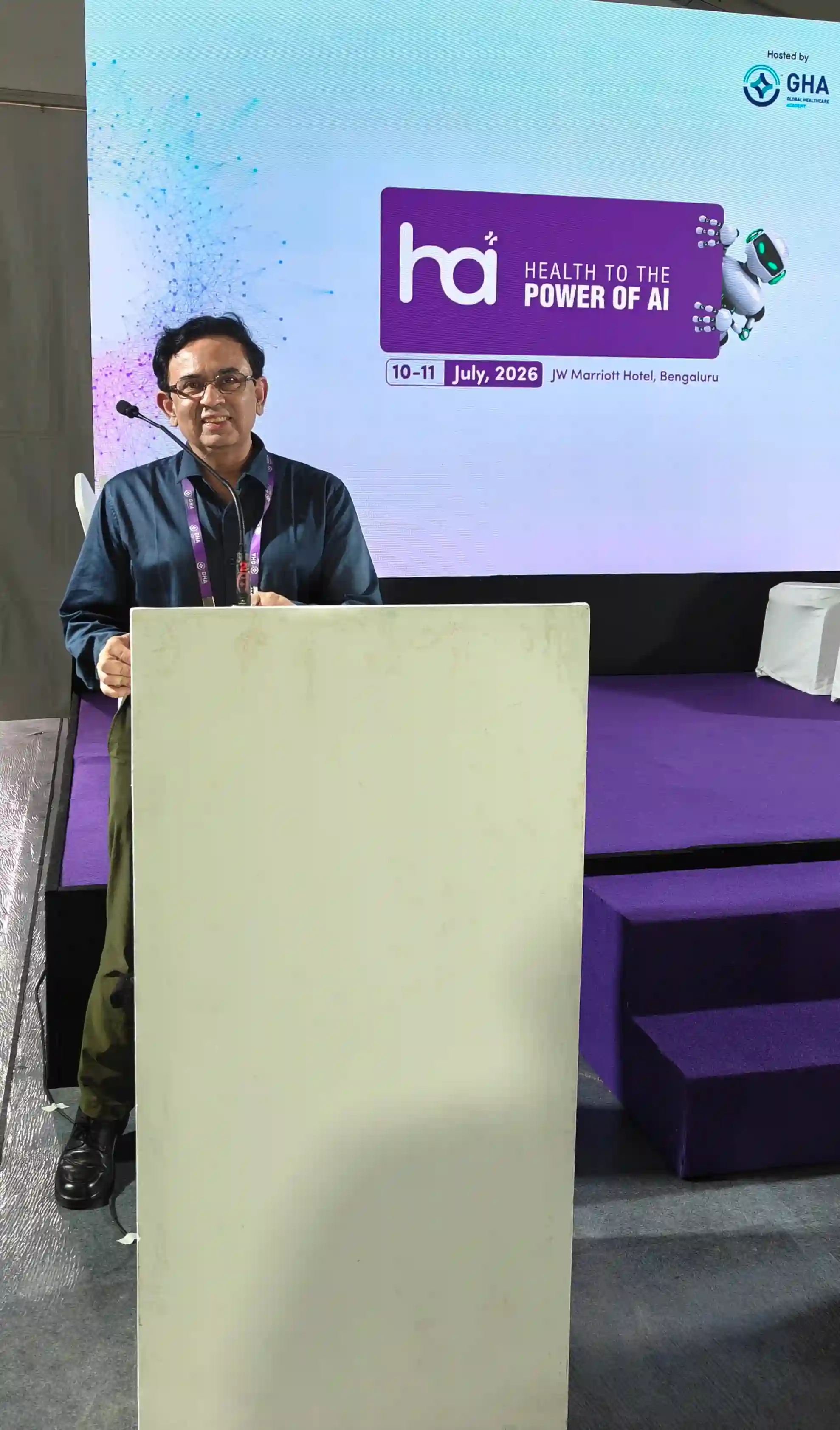 Dr. Arpan Gandhi speaking at the podium, Health to the Power of AI Conclave 2026