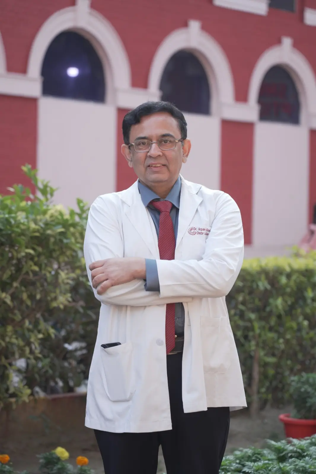 Dr. Arpan Gandhi in white coat at medical institution